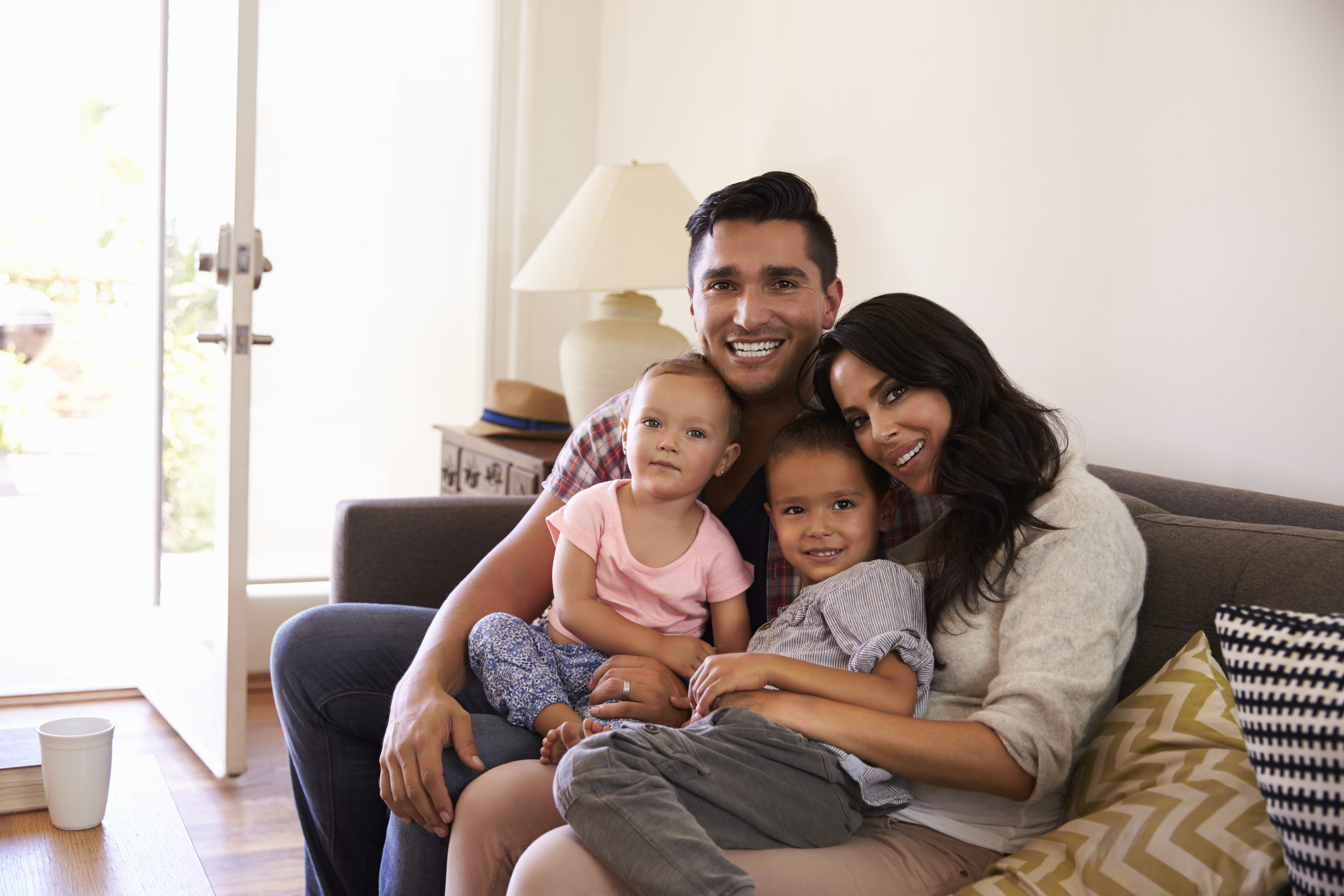 Happy Family Sitting On Sofa